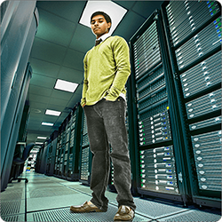 Man standing in front of wall of computers